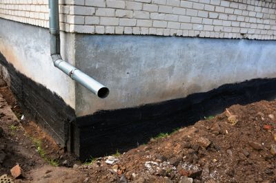 Drainage system installation at foundation base
