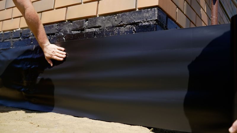 Waterproofing material being sealed on foundation